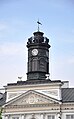 Tower with clock, weathervane, pediment, and columns