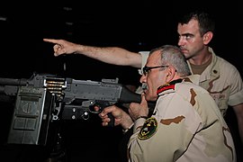 US Navy 091002-M-8488D-139 Rear Adm. Ali Hussein Al-Rubaye participates in a firearms training simulation.jpg