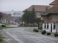 Zentrum mit der Schule des Dorfes, im Hintergrund die Kirche der rumänischen griechisch-katholischen Kirche Adormirea Maicii Domnului