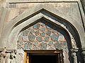 Intricately detailed tympanum above the rear portal