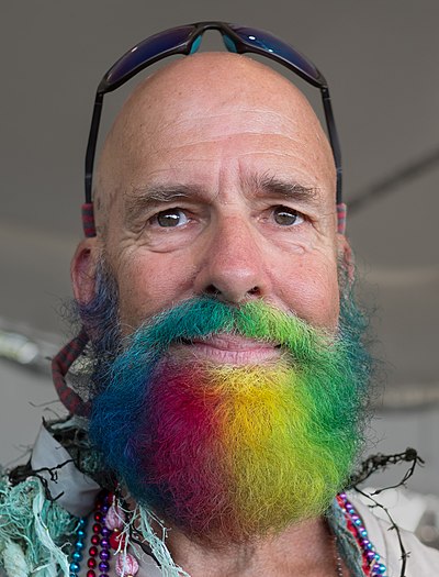 Man with a rainbow beard at the Mermaid Parade