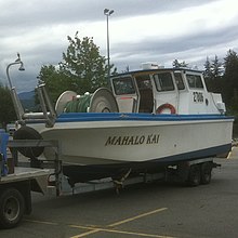 image of a commercial salmon bow picker, Mahalo Kai; drum holding net is located in the bow of the boat. The cabin is in the rear.