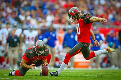 A player attempts a field goal.