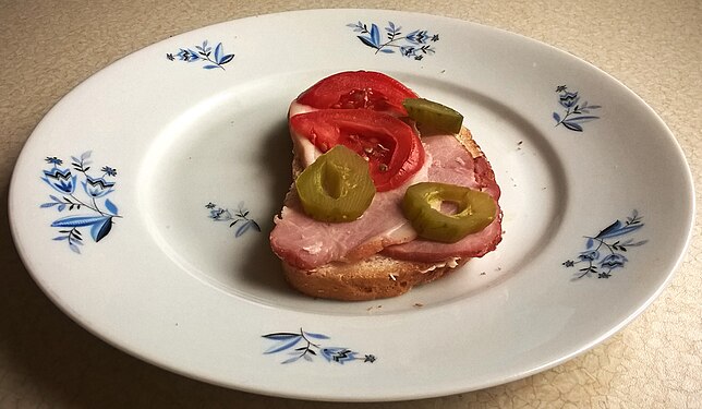 Sandwich for breakfast - wheat-rye bread with ham and importantvegetables.