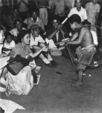 A Japanese war-orphaned begging boy spinning a hoop - Ueno Station, 1946