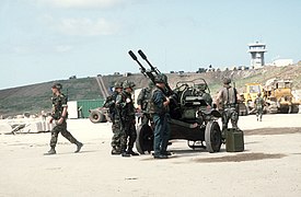 US military personnel examine a Soviet-made ZU-23 23mm anti-aircraft gun seized during Operation URGENT FURY DN-ST-85-02008.jpg