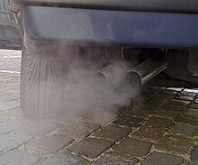 close-up of 2 exhaust pipes with whitish smoke