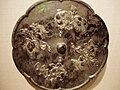 A bronze mirror with raised-relief decorations of wedding flowers, 8th century, Tang Dynasty