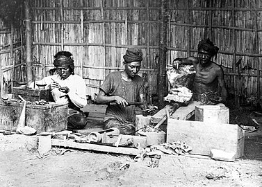 Goldsmith shop in Aceh, Sumatra, Indonesia during the early-20th century. The man in the middle may be a "Klingalees" (orang Keling), someone from South India