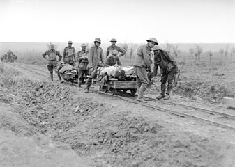 5th Australian Field Ambulance Company soldiers evacuating wounded from the front near Ypres in trench railway hand cars.