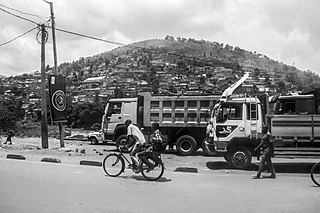 Bike taxi driver takes commuter to his destination in Kayonza