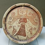 Fig. 3. Winged Gorgon with, volute nose, wide mouth, tusks/fangs, tongue, and beard, as Mistress of Animals flanked by geese; plate from Kameiros, Rhodes, British Museum A 748 (late seventh century BC)[68]