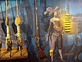 Mural que representa amarres de un barco, un mosquete de mecha (evolución del arcabuz), un capitán español y filones de oro puro. Pabellón de la Navegación, Sevilla, España.