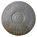 Anverso de moneda de 8 reales (plata) de Carlos IV de 1801 resellada en Cromford Mill, Gran Bretaña.