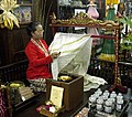 Sawijining wanita migunakaké malam lan canthing kanggo gawé Bathik Tulis ing Yogyakarta, Indonésia.