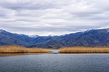 Lake with surrounding tree-covered hills