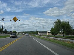 Along Dunnings Highway (PA 164); the municipal building in on the right in the background