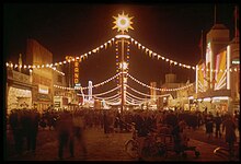 The "Gayway" at the Golden Gate International Exhibition, photographed here at night in 1940 by Charles Cushman, hosted numerous sideshow-style attractions, including "Sally Rand's Nude Ranch" (neon sign, at left), a burlesque show.