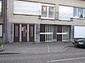 House that stands in Belgium and Netherlands at the same time. State border is marked by the line of white plates on the sidewalk.