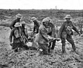 Britiske sanitetssoldater under slaget ved Passchendaele, de vasser i gjørme til knærne. Foto: John Warwick Brooke (1886–1929)