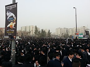 Large crowd of young men, dressed in black