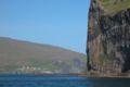 Kirkja from the distance, cliff of Svínoy in the foreground