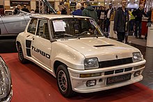 A small rear-mid-engined car with three doors