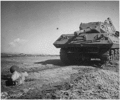 Soldier in fox hole hurls hand-grenade at tank destroyer at Commando training camp in Camp Carson, Co. , 04/24/1943