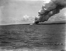 Matavanu lava flowing into the ocean along the coast and sending plumes of smoke skywards, 1905