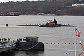 Sailors aboard the decommissioned nuclear submarine Nautilus salute the sailors aboard Miami as the boat returns home to Naval Submarine Base New London following an eight-month deployment. (2 December 2009)