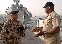 US Navy 070226-N-8560S-005 USS Anzio (CG 68) Command Master Chief William Seegars talks to Iraqi navy Chief Warrant Officer 2nd Class Abdul Majeed during a tour of the ship.jpg