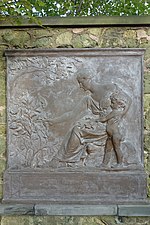 Bronze tablet of a woman handing a plant to a young boy