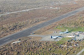 U.S. Marine Corps HC-130 Hercules aircraft assigned to the 3rd Marine Expeditionary Brigade and other military aircraft sit on the tarmac at an airport in Guiuan, Philippines, waiting to airlift Philippine 131117-N-XN177-381.jpg