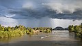 83 Landscape with stormy clouds and a pirogue on the Mekong at golden hour in Si Phan Don uploaded by Basile Morin, nominated by Basile Morin