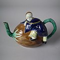 Coloured glazes Oriental Boy on Coconut Teapot and cover, c. 1870