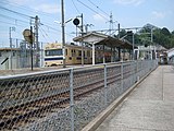 市道から広島方面を見たホーム。右側に少し見える建物が駅舎（2009年8月）