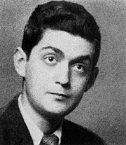 Black-and-white headshot of a young man with a short clean-cut hairstyle wearing a suit jacket and tie