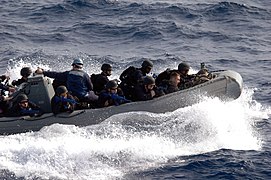 US Navy 071118-N-0167B-038 Members of the security force aboard the guided-missile cruiser USS Shiloh (CG 67) ride a rigid hull inflatable boat toward the ship as part of a visit, board, search, and seizure (VBSS) drill.jpg