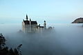 Neuschwanstein Castle during early evening in November 2011. The fog in the valley below makes it look like a castle above the clouds.