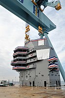 The 555-metric ton island in place after being lifted into position on the ship's flight deck during a ceremony at Newport News Shipbuilding in January 2013.