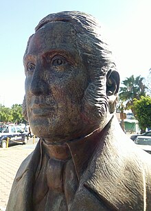 Un busto de bronce representando a un hombre vestido según la usanza del siglo XIX.