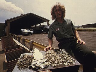 An employee of the Logan-Long recycling plant in Franklin demonstrates recyclable products. Growing environmental consciousness in the United States has led to huge recycling efforts for materials such as glass, paper, steel, and aluminum.