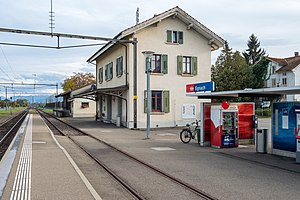 Three-story building beside two railway tracks