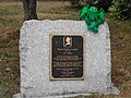 A photgraph of the plaque with a stuffed Cthulhu