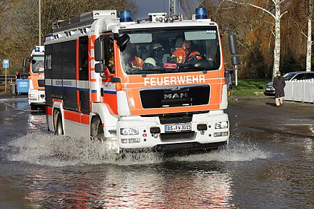 A fire engine in a flooded street