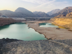 The wadi with the North-Western Hajar Mountains in the background. Note that Jebel Jais, the UAE's highest mountain, is nearby.