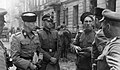 SS-Gruppenführer Heinz Reinefarth "Butcher of Wola" (left, in Cossack headgear) and the Regiment III of Cossacks of Jakub Bondarenko during Warsaw Uprising around Wolska street. Third Regiment of Cossacks contained a mix of Cossacks from many regions, and Jakub Bondarenko was commanding 5th Regiment of Kuban Cossack Infantry