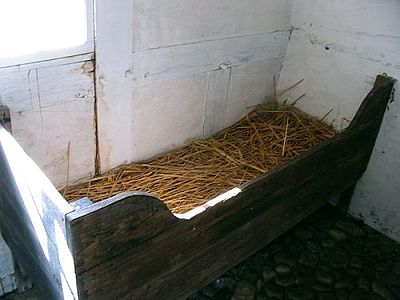 A bed filled with loose straw, but without the bedding, at a museum in Denmark
