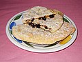 Two Banbury cakes, one having been cut into two pieces