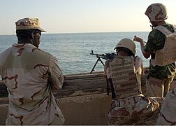 US Navy 070804-N-8560S-001 Gunner's Mate 2nd Class Nickel Samuel assigned to Mobile Security Detachment (MSD) 24 observes Iraqi marines participating in a live-fire exercise.jpg